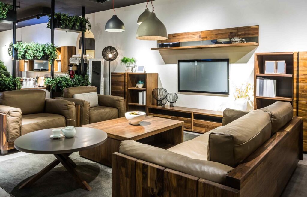 Modern living room featuring teak furniture Malaysia with leather sofas, a teak coffee table, and wooden shelving for a stylish, durable design.