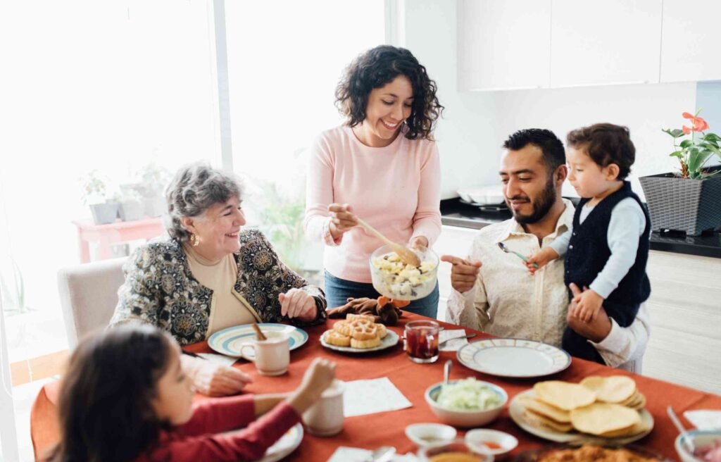 Family enjoying a meal together at the dining table, highlighting how dining room furniture malaysia strengthens tradition, connection, and home life.